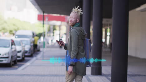 man standing on sidewalk using smartphone app, displaying audio waveform graphic for technology
