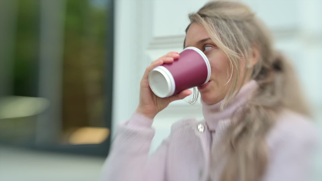 Brunette woman drinking coffee outside