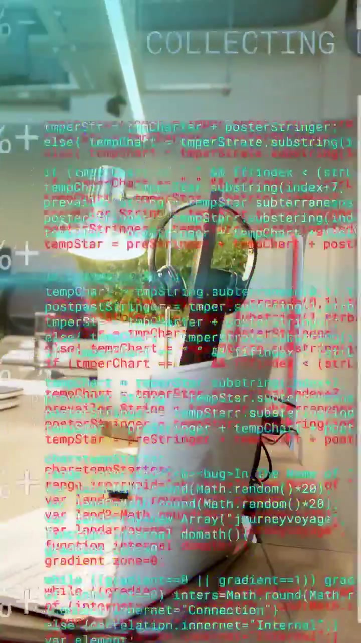 Vertical video: Glitch starting laptop and stand shifting as HUD and code overlaying desk as noise