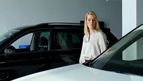 woman looking at cars in showroom