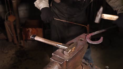 blacksmith forging a horseshoe