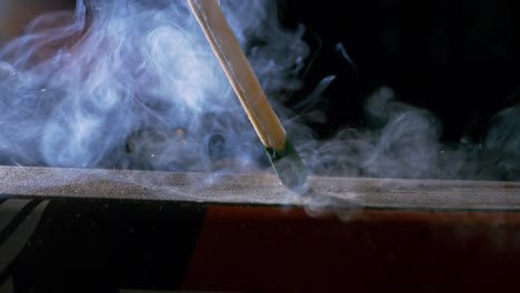 burning matchstick close-up on a dark background. shot on super slow motion camera 1000 fps.