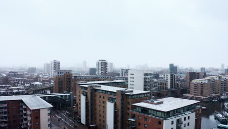 rising drone shot of heavy snow in limehouse london