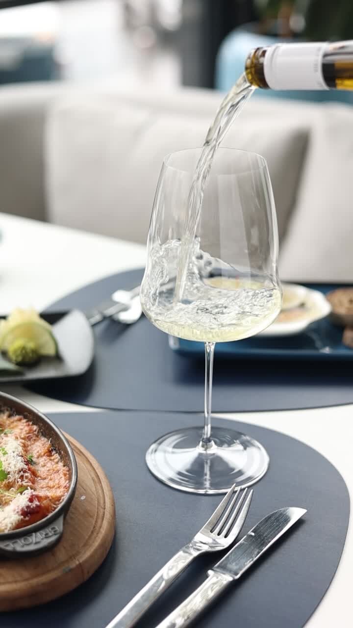 Pouring white wine at a restaurant