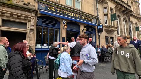 people gathering outside a pub in edinburgh