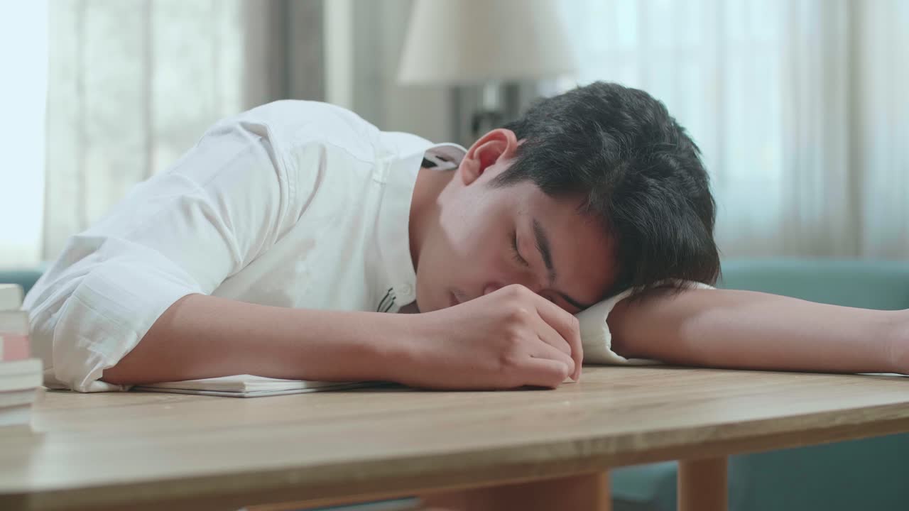 Close Up Of Asian Man Student Sleeping While Studying At Home