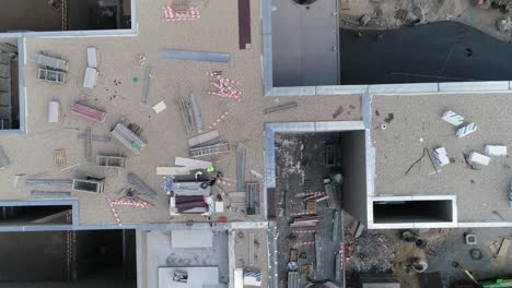 new building construction. construction workers in the roof