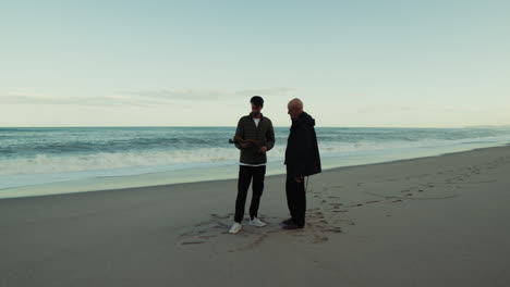 father and son enjoy a father's day at the beach