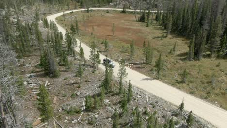 aerial following truck on dirt road in colorado