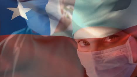 Digital-composition-of-chile-flag-waving-against-female-senior-surgeon-wearing-face-mask-at-hospital