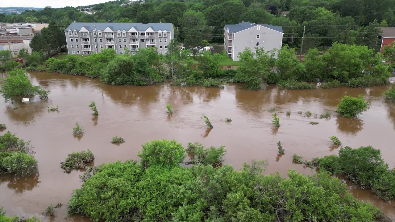 Flooded river overflowing into home backyards and residential property