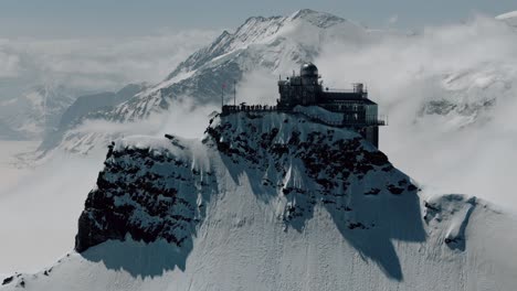 disparo en círculo lento de jungfraujoch con nubes rodando sobre los picos