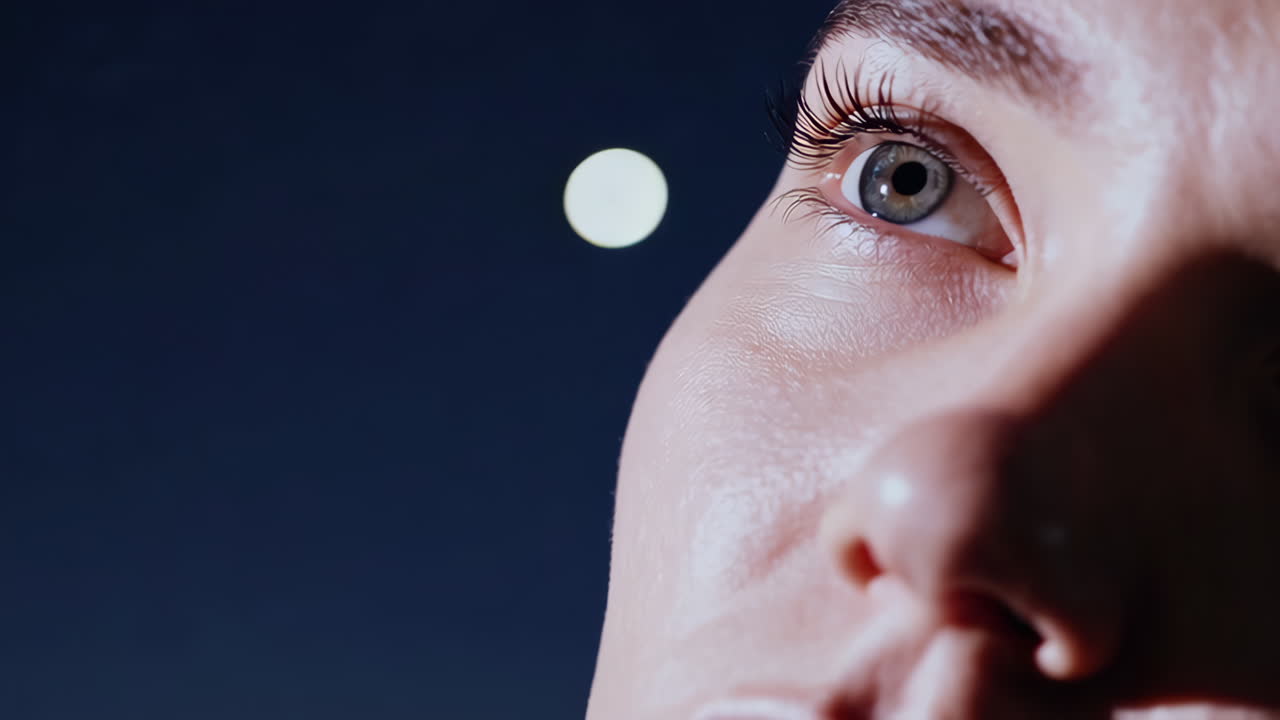Woman looking up at the night sky