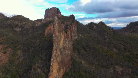 Amazing-natural-rock-formation,-Australian-outback-at-sunset,-aerial-arc-shot