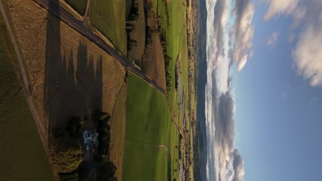 high drone view of a typical green landscape in rural tasmania in a vertical shot