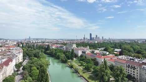 Drone-pull-back-above-river-in-Vienna,-Austria