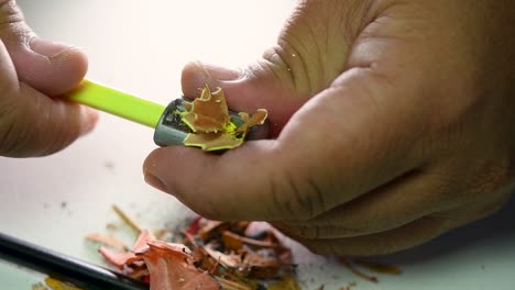 Footage-of-hands-slowly-sharpening-a-pencil-and-some-coloured-pencils-with-a-Wedge-Pencil-Sharpener