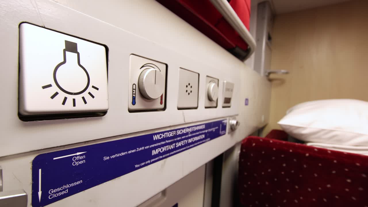 Light button on a moving night jet train, close up
