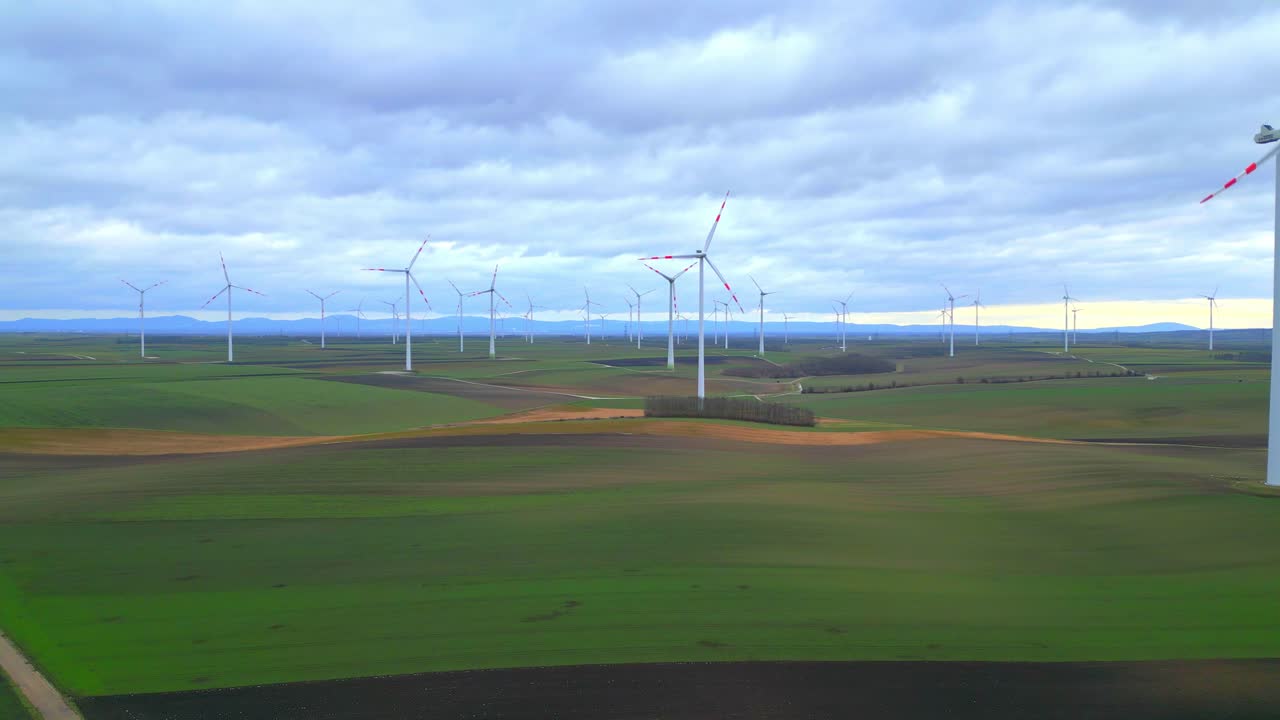 Wind Turbines Generating Alternative Energy At The Wind Farm