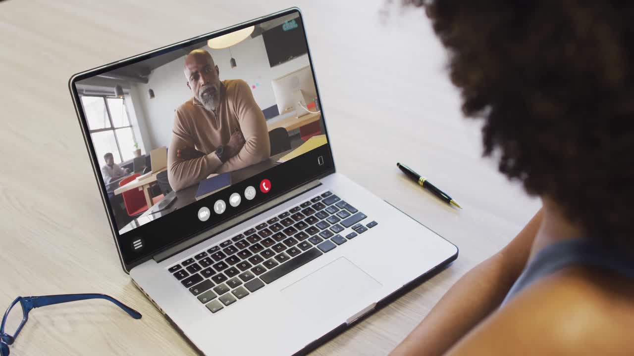 Animation of african american woman having video call on laptop