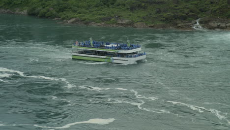 maid of the mist tour boat travels up the niagara river towards the falls