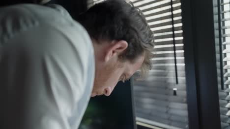 spy or secret agent reviews classified documents spread across office desk, discreetly snapping photos with smartphone. espionage, covert operations, and intelligence gathering, surveillance. thief