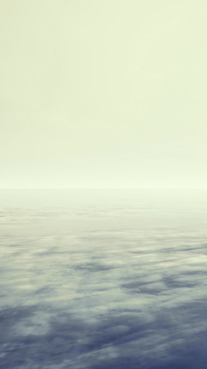Open water stretches towards the horizon under cloudy sky