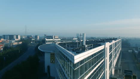 office building with transmission antenna on the rooftop at park west business park in dublin, ireland - empty during covid-19 crisis - aerial drone