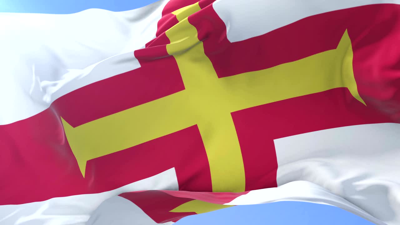 Flag of Guernsey waving at wind in slow, loop