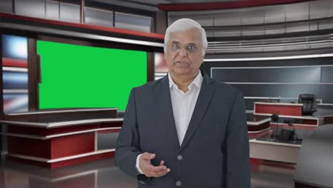 Indian-senior-journalist-reading-news-in-green-screen