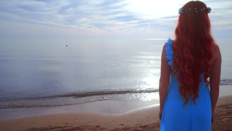 Redhead-woman-looking-at-sea.-Rear-view-woman-beach.-Woman-on-sea-beach