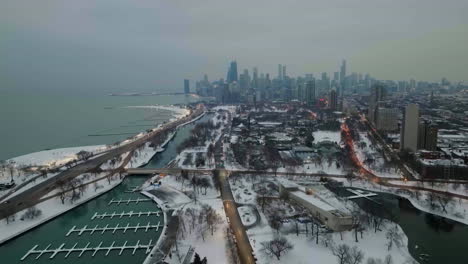 aerial view following cars on the cannon drive in lincoln park, winter evening in chicago, usa