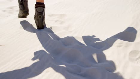 woman in boots walking in the desert 4k