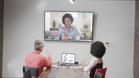 Diverse-business-people-on-video-call-with-african-american-female-colleague-on-screen