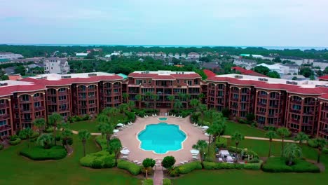 Drone-view-flying-away-from-the-center-of-the-Mediterranea-Condominium-and-resort-in-Miramar-beach-near-Destin-Florida