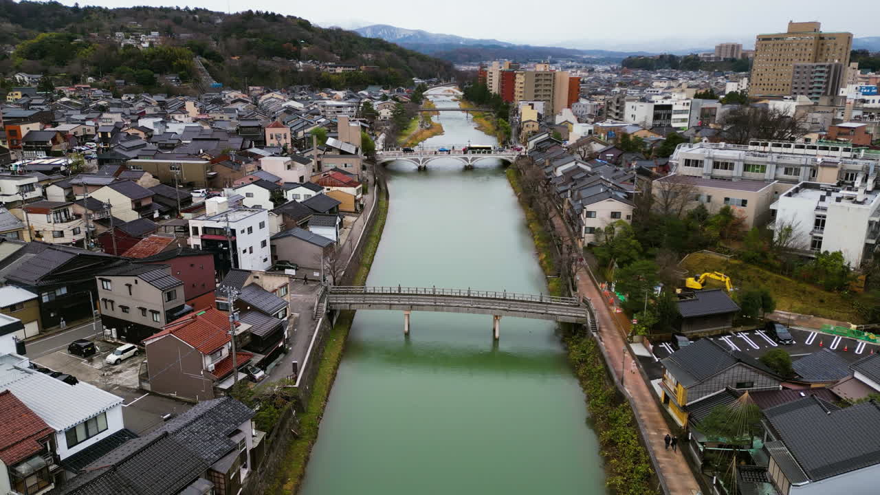 Aerial view following the river through the city of Kanazawa, fall day in Japan