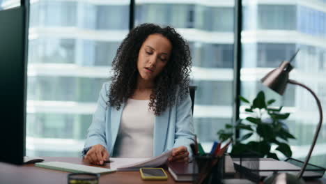 woman worried work failure sitting office desk close up. girl manager tired.
