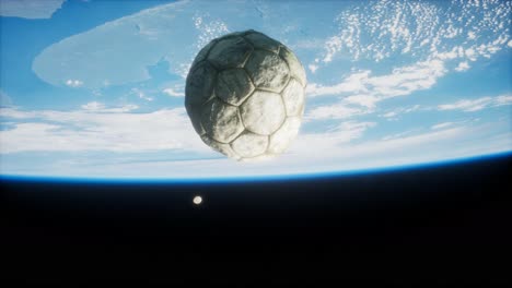 old soccer ball in space on earth orbit