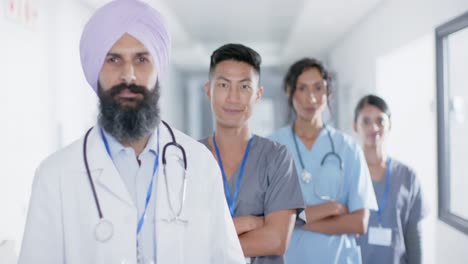 portrait of diverse doctors and nurses smiling in corridor at hospital, in slow motion