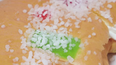 candied fruit and sugar on roscon de reyes christmas pastry, closeup detail