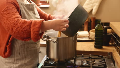 woman cooking pasta in the kitchen