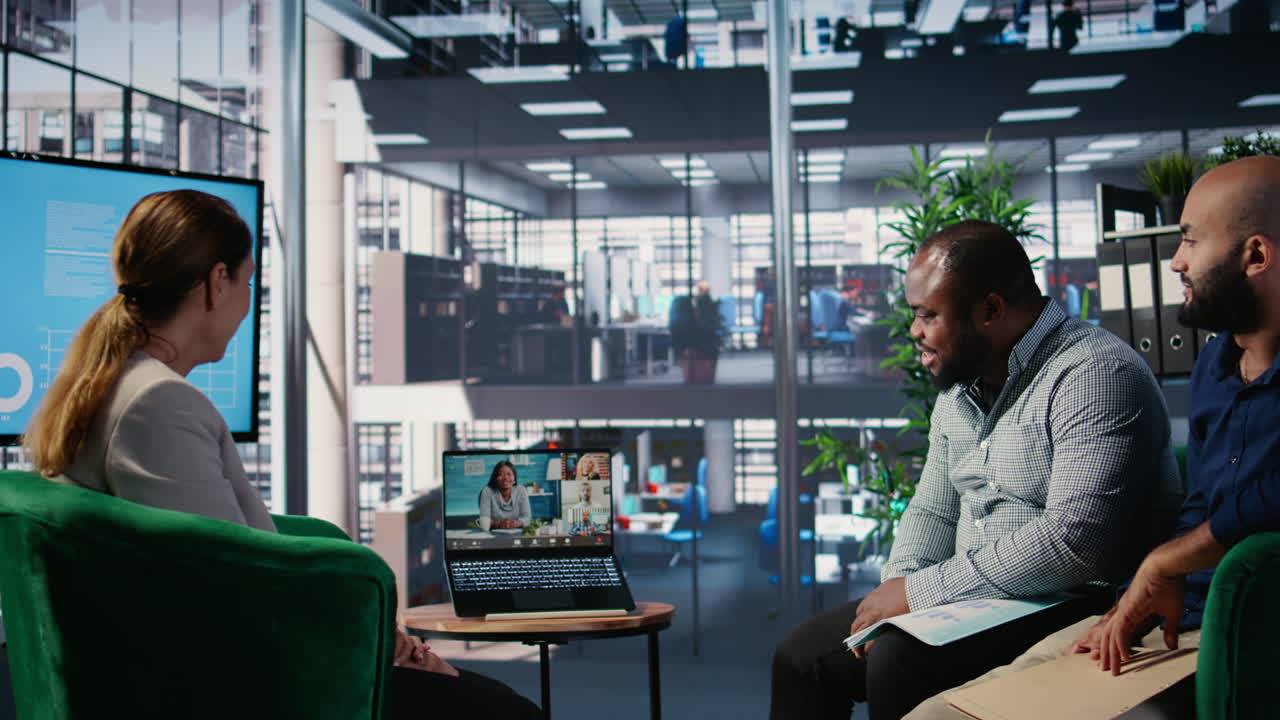 Multiethnic business leaders engaged in a web video conference in office lobby