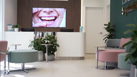 bright and inviting reception area featuring a smiling face digital display, showcasing a modern and welcoming atmosphere for visitors