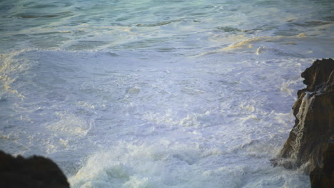 el mar inquieto lava las rocas por la mañana en la orilla del mar. las olas del océano crean espuma