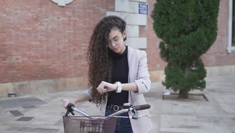 young woman checking time on bicycle