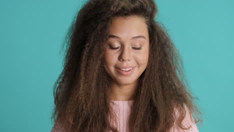 Caucasian-curly-haired-woman-drinking-water-and-coughing-in-front-of-the-camera.