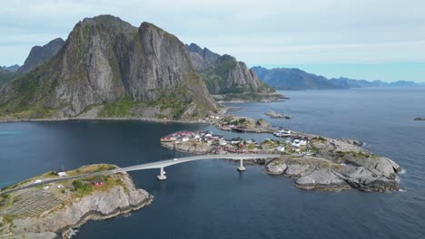 scenic road bridge to hamnoy village and fjords in lofoten islands, norway - aerial 4k