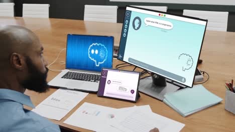 African-american-businessman-using-computers-with-data-processing-in-office