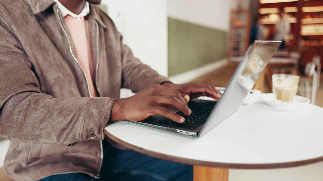 Man working on laptop in cafe
