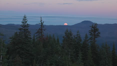 close up of the harvest supermoon rising over the cascade mountains in southern oregon